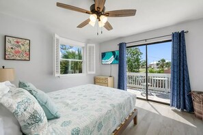 King-size bed with access to patio with sitting area. Smart TV in the room.