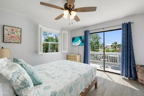 King-size bed with access to patio with sitting area. Smart TV in the room.