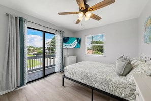 Queen-size bed with access to patio with sitting area. Smart TV in the room.