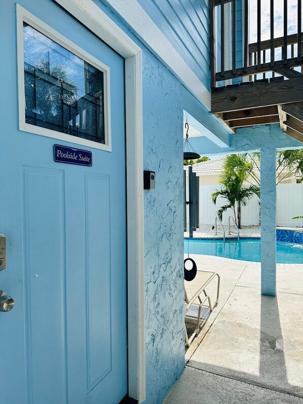 Entrance to the Poolside Suite. There is a step up into the unit, and a keypad lock. You’re literally just a few steps away from the swimming pool and a few more steps to the wood deck overlooking the canal, where the kayaks and SUPs are kept.