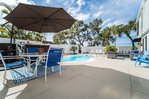 Shared pool deck offering a sparkling pool, with built in seats and jets. Plenty of space to social distance. Tables, chairs and sun loungers for your convenience as well as a gas BBQ grill.