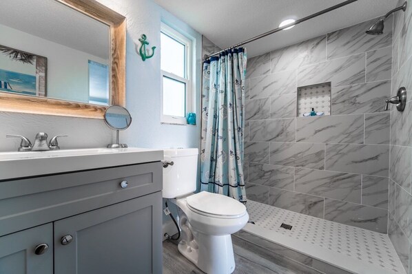 Brand new 2021: full bathroom featuring a luxury spa like step in shower.

Bathroom is accessible via a modern barn door.