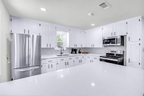 Quartz countertops with brand new stainless steel appliances. 