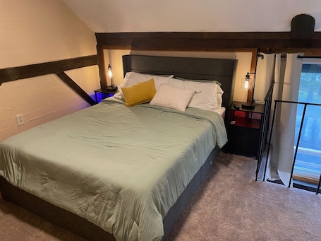 Upstairs bedroom with queen bed, nightstands with charging stations