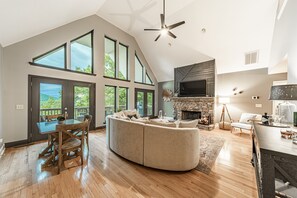 Relax in your cozy mountain retreat, where soaring windows frame your sunset views, a stone fireplace warms your evenings, and every detail invites you to unwind and reconnect.