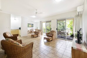 The tiled living area features four large, comfy armchairs for relaxing around the TV.