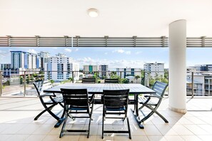 A sprawling private balcony, with a six-seater table setting, offers plenty of space to relax and entertain. 