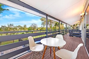 A spacious back balcony offers green, leafy views of the adjoining parkland.  
