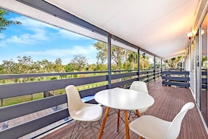 A spacious back balcony offers green, leafy views of the adjoining parkland.