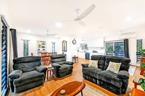 The living area provides comfy seating to settle in with a movie after a day of sightseeing while air-conditioning and ceiling fans ensure year-round comfort.