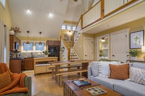 Open dining area & living room with electric fireplace & Smart TV with streaming.