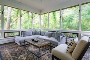 Burroughs Hall features a sun room off of the back porch with forest views and a spacious seating area.