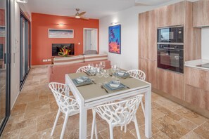 Contemporary Dining Area with Orange Wall