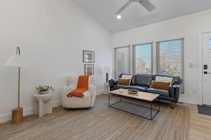 This living room has large windows for plenty of light.