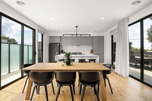 Light-filled dining room comfortably seating eight people.