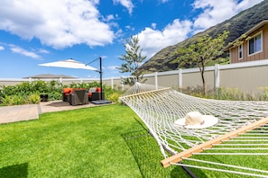 Backyard oasis with a hammock and comfortable seating.