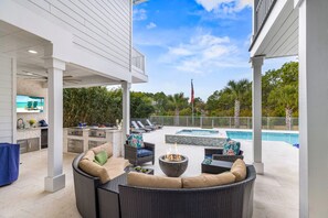 Outdoor sitting area with fire pit and entry to outdoor kitchen