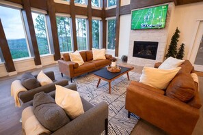 Living area with a cozy fireplace, TV and fantastic views