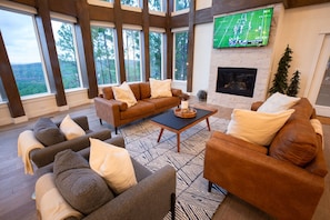 Living area with a cozy fireplace, TV and fantastic views