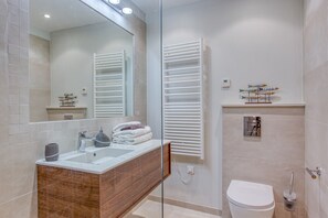 State-of-the-art bathroom with Italian walk-in shower and heated towel rack