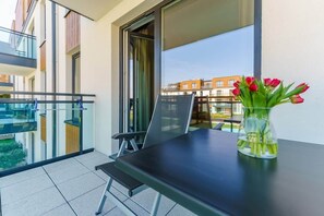 The balcony's stylish design complements the apartment's decor. 