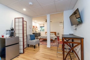 A functional kitchenette with a microwave and mini fridge as well as an assortment of complimentary coffee, tea, and microwave popcorn.