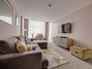 Spacious living area with comfy sofa & Smart TV