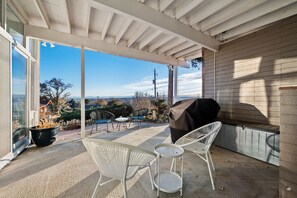 Covered patio with seating and grill