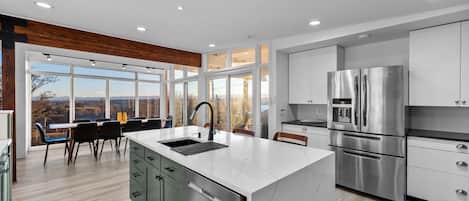 Fully stocked kitchen - stunning stainless steel appliances, kitchen island, and amazing views