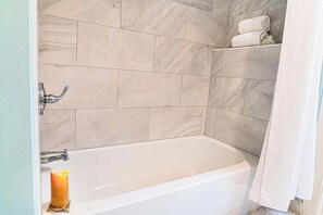 Bathroom has shower-tub combo
