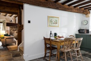 Kitchen leading to the sitting room and stairs to the first floor