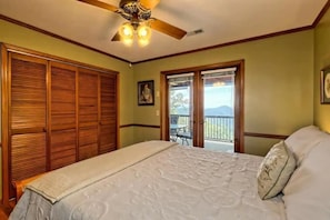 Guest bedroom with a very comfy queen mattress. Double doors open up the the large screened porch. Beautiful mountain views from the bed! This room also offers a TV with Direct TV.