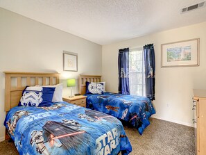 Spacious bedroom with vibrant bedding, perfect for families or kids.