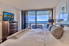 Master bedroom with king bed, private balcony, TV, private en-suite bathroom.
