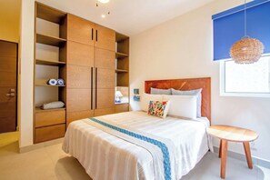 Luxury meets coastal calm: Queen bed, fluffy pillows, plush towels, secure safe—a blend of comfort .