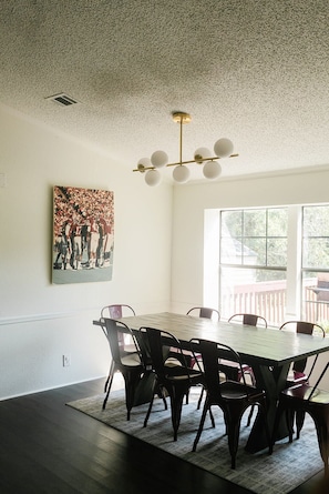 Dining area with vintage TAMU art - additional chairs/leaves available.
