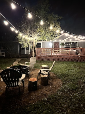 Firepit at night with patio lights