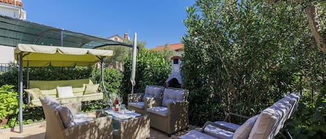 Plant, Sky, Property, Shade, Outdoor Furniture, Building, Leisure, Chair, Public Space, Grass