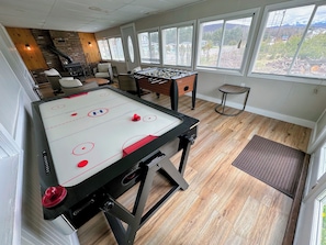 Enjoy the 4-season porch with fireplace, foosball, and air hockey