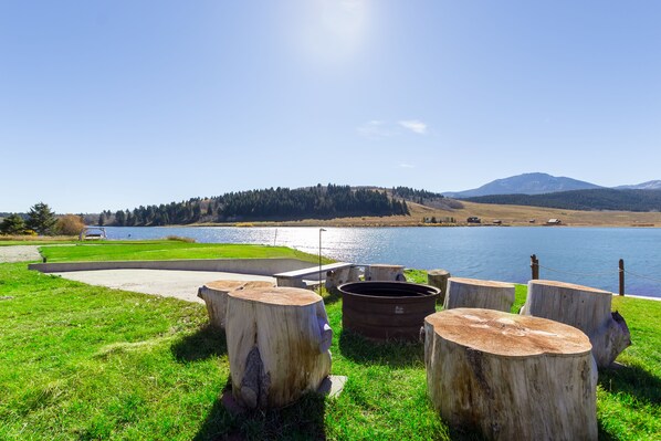 Right off the river sits a Wood burning fire pit with natural seating all around.