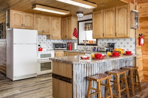 Step into the stunning kitchen at Red Rock Lakeview, where culinary adventures await. Fully equipped and spacious, it's perfect for whipping up delicious meals and creating unforgettable dining experiences amidst the beauty of Island Park, Idaho.