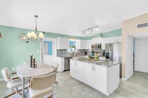 Full size kitchen and dining room area. The dining table has 4 seats.