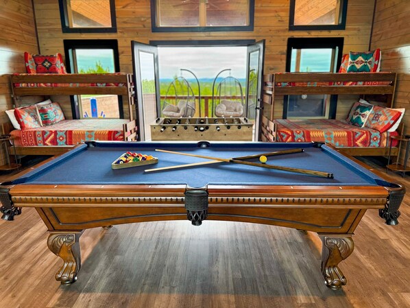 Upstairs bunk room and game room with private deck.