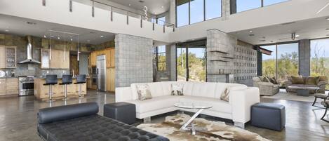 Open and spacious modern living room with high ceilings and natural light, perfect for relaxation or entertainment.