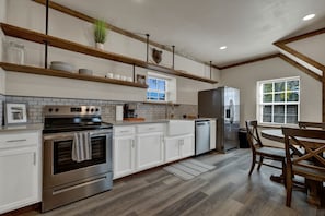 Full kitchen with stainless steel appliances.