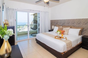 The master bedroom has a king bed and  and direct access to the balcony