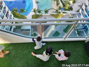 View from our unit Balcony to Amenities Wavepool, White Sand Beach & Club House