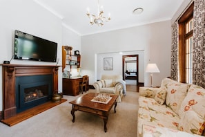 The formal lounge room has the ambience of a by-gone era. Play a game of chess or watch a spot of TV—all while enjoying the warm glow of the fire.