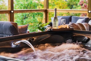 Come soak in luxury on our covered deck, with panoramic Smoky Mountain views