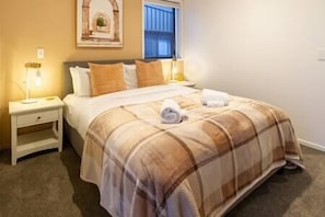 Spacious Queen bed with hotel quality towels and linen